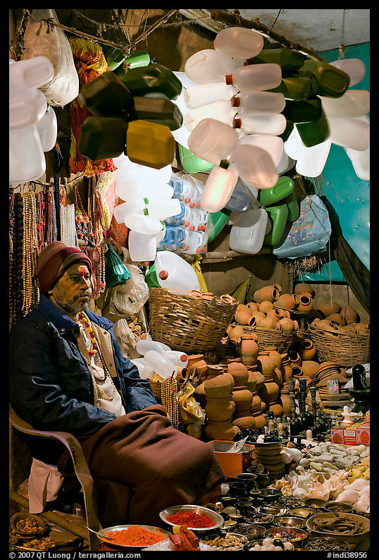 Man selling water jugs and other supplies for pilgrims near the Ganges River. Varanasi, Uttar Pradesh, India