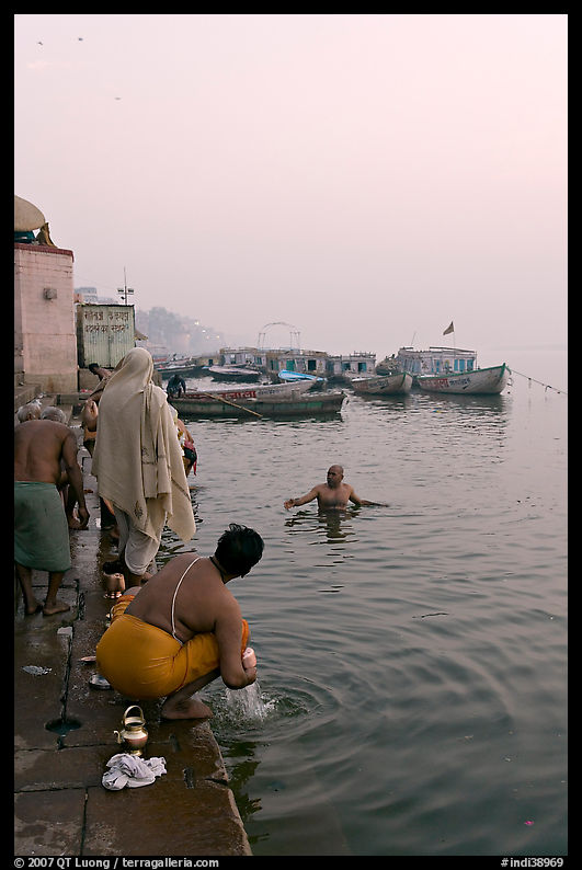 Hindu men dipping in the Ganges River at dawn. Varanasi, Uttar Pradesh, India