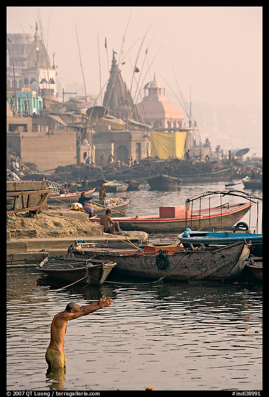 Man with arms stretched standing in Ganga River. Varanasi, Uttar Pradesh, India