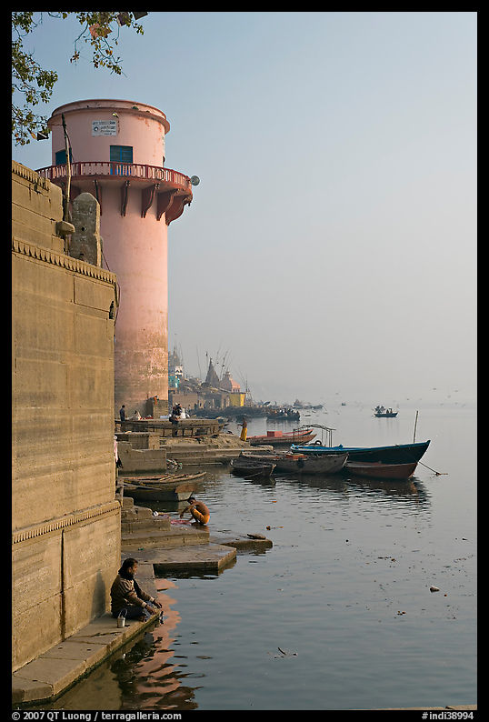 Man sitting on edge of Ganges River. Varanasi, Uttar Pradesh, India