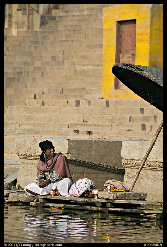 Man sitting near unbrella. Varanasi, Uttar Pradesh, India