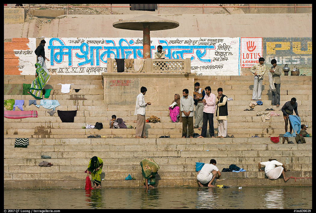 People washing cloths, steps, and Indi inscriptions. Varanasi, Uttar Pradesh, India