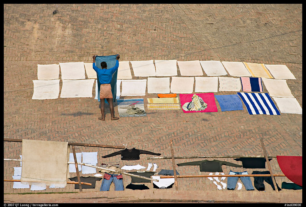Man laying out laundry for drying. Varanasi, Uttar Pradesh, India