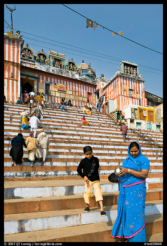 Woman and boy on temple steps, Kedar Ghat. Varanasi, Uttar Pradesh, India