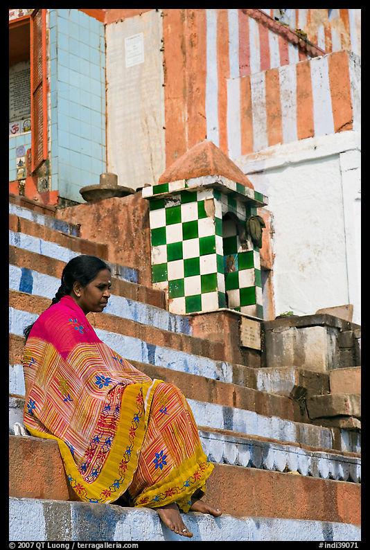 Woman sitting on temple steps. Varanasi, Uttar Pradesh, India