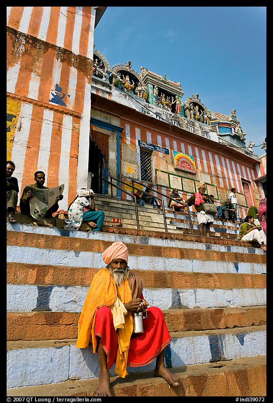 Holy man sitting on temple steps, Kedar Ghat. Varanasi, Uttar Pradesh, India