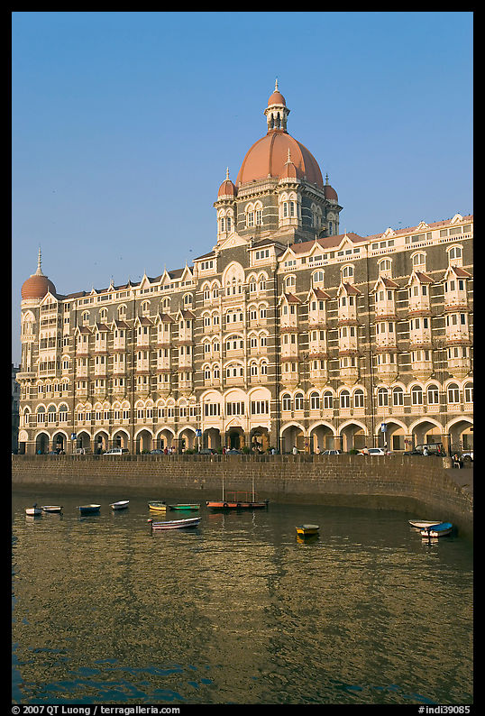 Taj Mahal Palace Hotel and small boats in harbor. Mumbai, Maharashtra, India