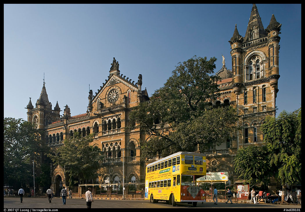 Yellow double-decker bus in front of Victoria Terminus. Mumbai, Maharashtra, India