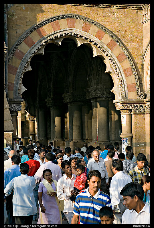 Crowd pass beneath an archway, Chhatrapati Shivaji Terminus. Mumbai, Maharashtra, India