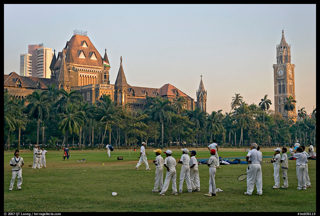 Boys in cricket attire on Oval Maidan, High Court, and Rajabai Tower. Mumbai, Maharashtra, India