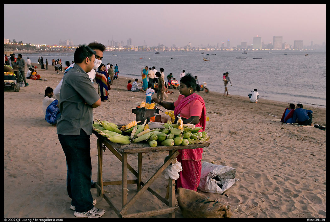 Food stall selling braised corn at twilight,  Chowpatty Beach. Mumbai, Maharashtra, India