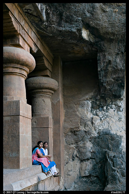 Women sitting at entrance of cave, Elephanta Island. Mumbai, Maharashtra, India