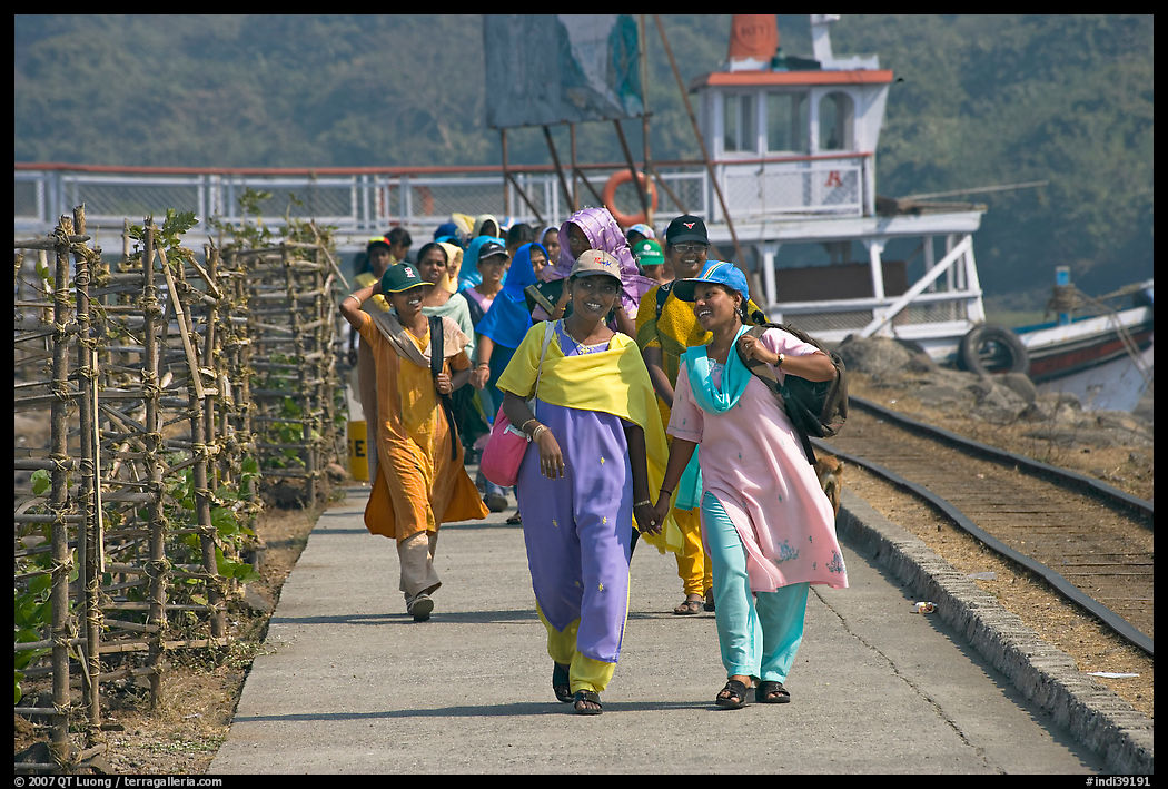 Women walking on  jetty, Elephanta Island. Mumbai, Maharashtra, India