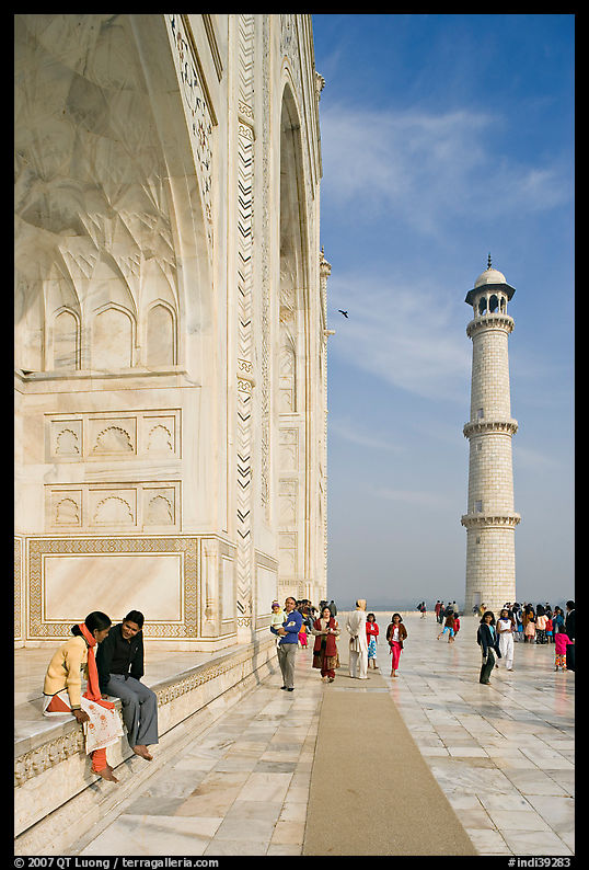 Couple sitting on side pishtaq and visitors strolling on platform, Taj Mahal. Agra, Uttar Pradesh, India