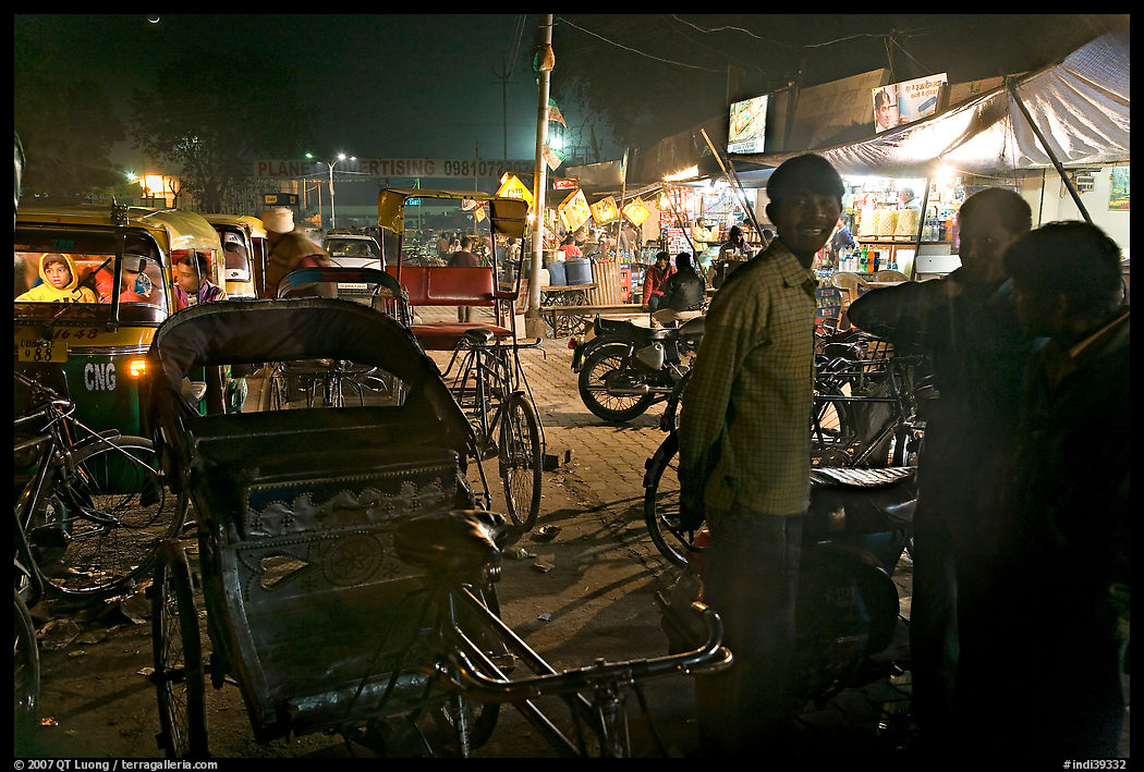Cycle-rickshaws and vending booths at night, Agra cantonment. Agra, Uttar Pradesh, India