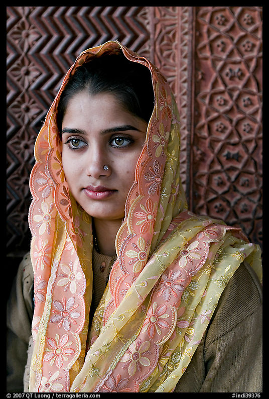 Young woman with embroided scarf, in front of Rumi Sultana wall. Fatehpur Sikri, Uttar Pradesh, India