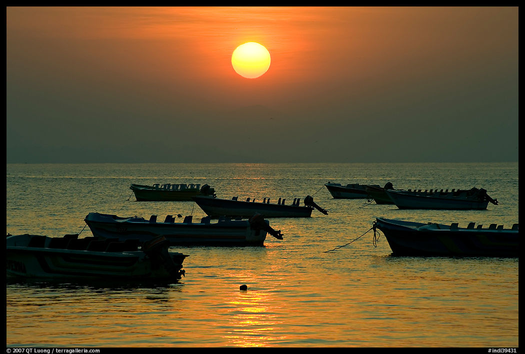 Boats anchored in bay and sunrise, Dona Paula. Goa, India