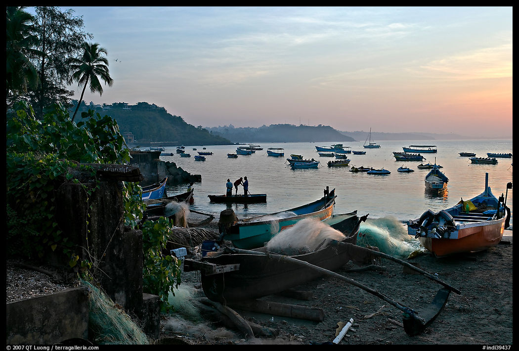 Fishing boats on beach, sunrise. Goa, India