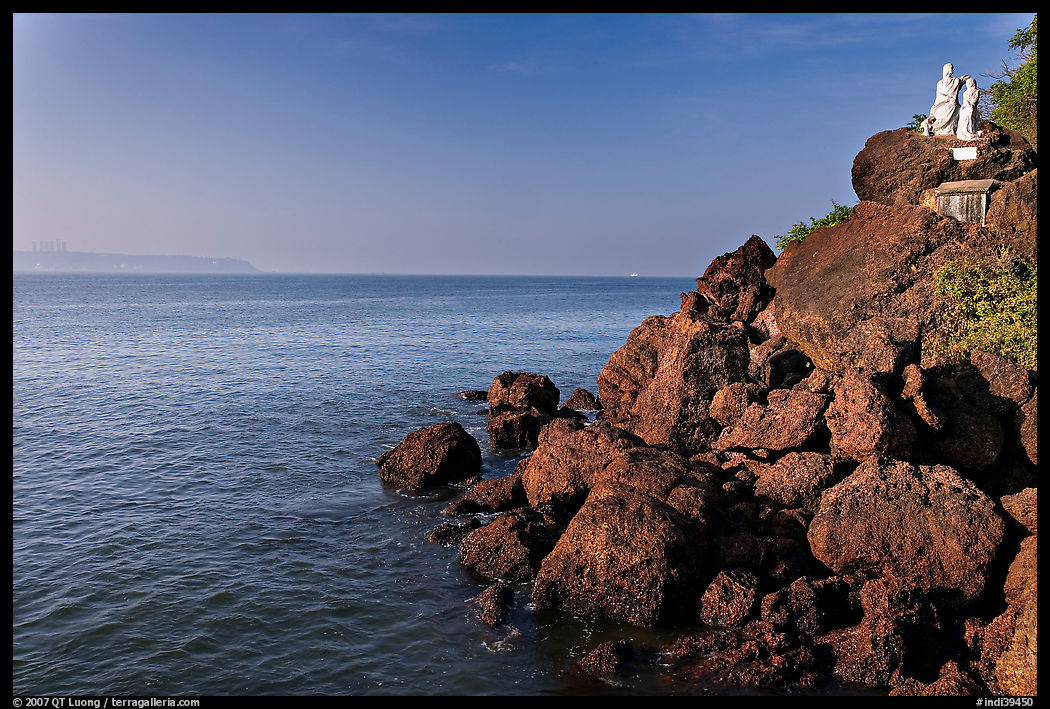 Boulders and christian statues at the edge of ocean, Dona Paula. Goa, India
