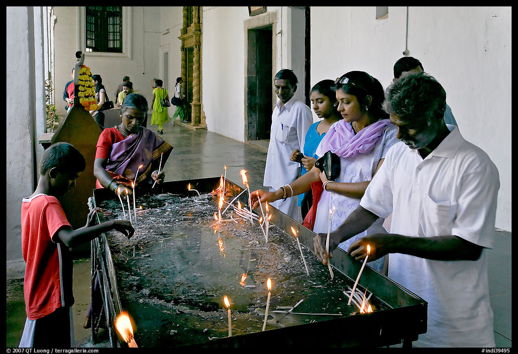 Indian people burning candles, Basilica of Bom Jesus, Old Goa. Goa, India