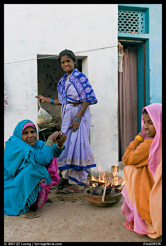 Women cooking outside in village. Khajuraho, Madhya Pradesh, India
