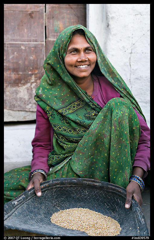 Woman sorting grains. Khajuraho, Madhya Pradesh, India