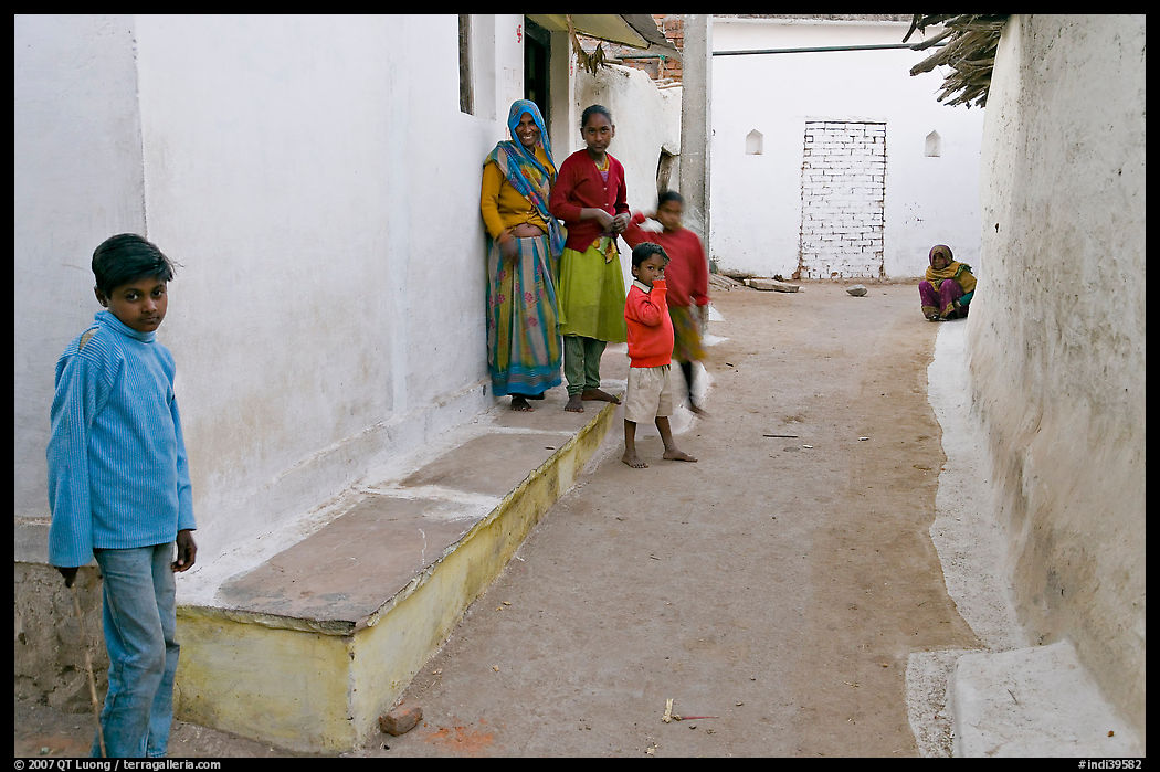 Family in village alley. Khajuraho, Madhya Pradesh, India