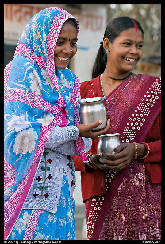 Women with pots used for religious offerings. Khajuraho, Madhya Pradesh, India