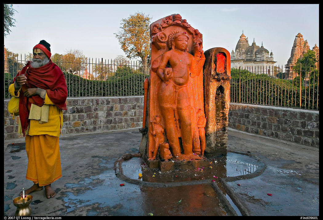 Holy man next to Shiva image. Khajuraho, Madhya Pradesh, India