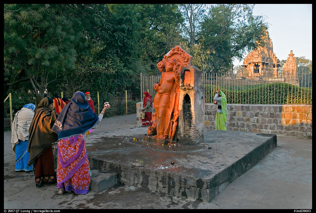 Women throwing water at  Shiva image. Khajuraho, Madhya Pradesh, India