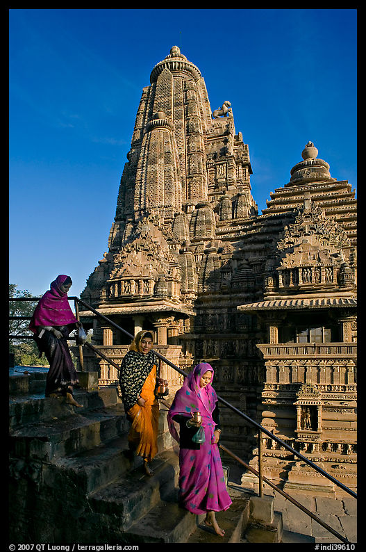 Women going down stairs in front of Lakshmana temple. Khajuraho, Madhya Pradesh, India