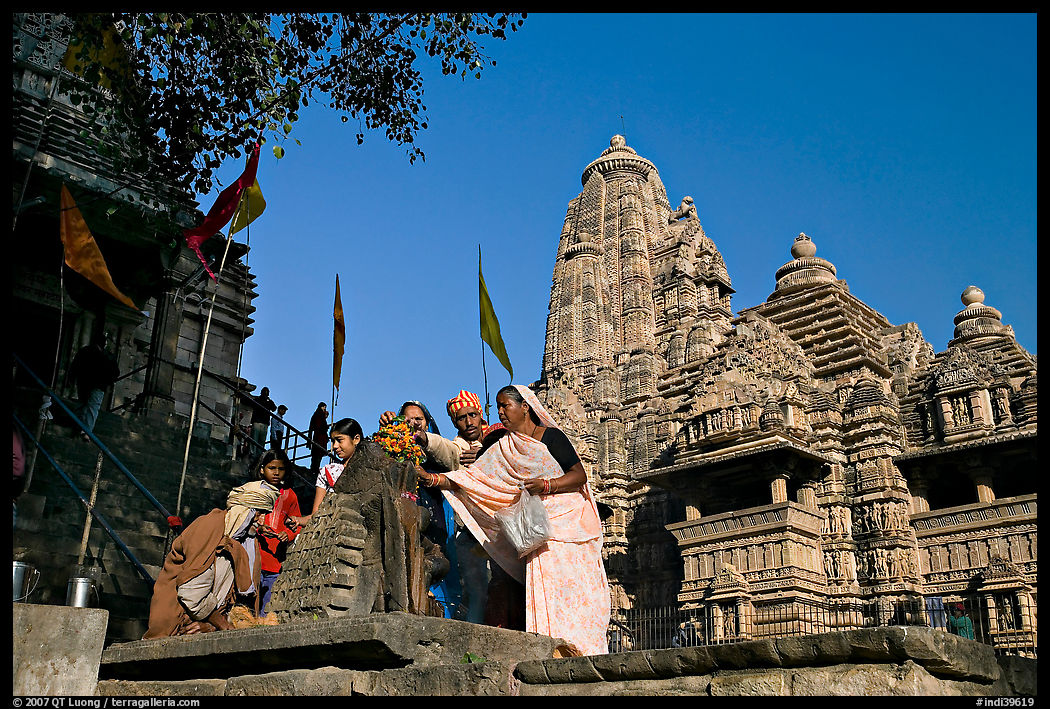 Worshippers making offering at Matangesvara temple with  Lakshmana behind. Khajuraho, Madhya Pradesh, India