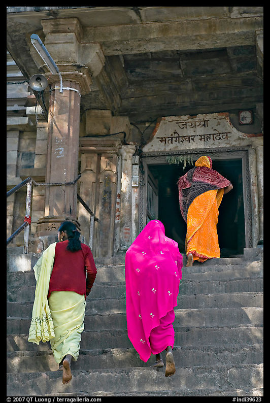 Women climbing up stairs on Matangesvara temple. Khajuraho, Madhya Pradesh, India