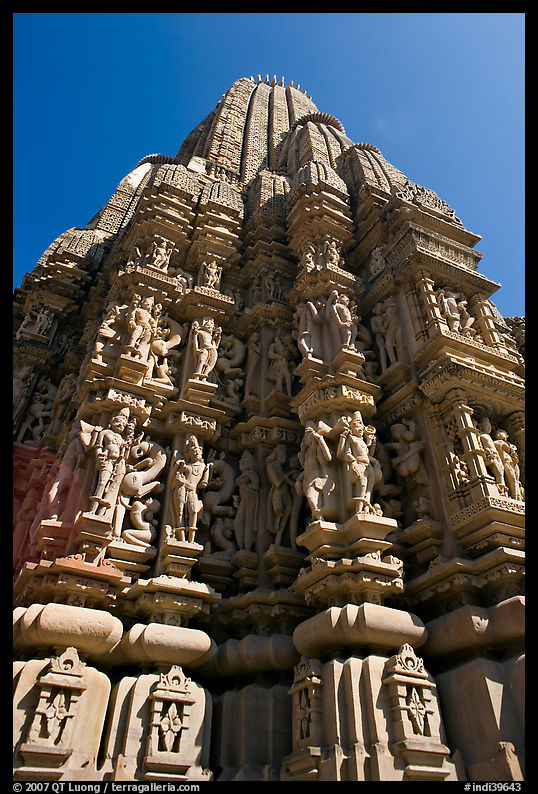 Sculptures and sikhara of Devi Jagadamba temple from below. Khajuraho, Madhya Pradesh, India