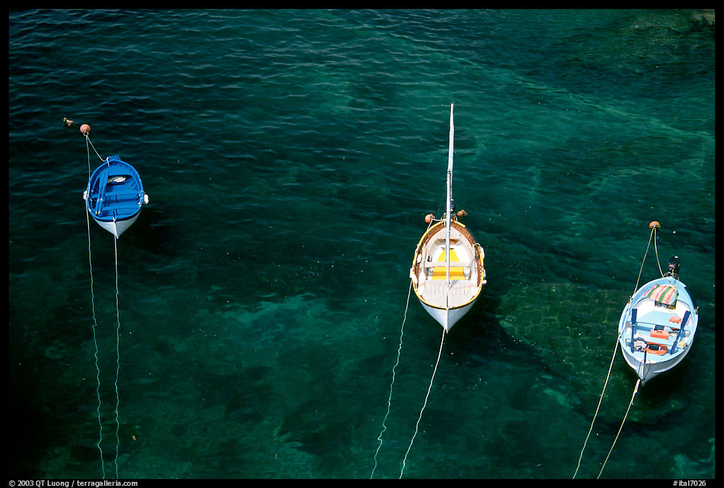 Three small boats in emerald waters, Riomaggiore. Cinque Terre, Liguria, Italy