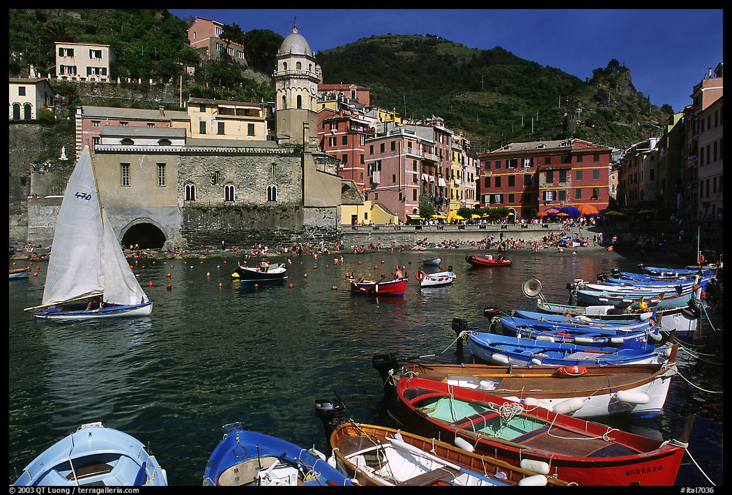 Colorful fishing boats in the harbor and Piazza Guglielmo Marconi, Vernazza. Cinque Terre, Liguria, Italy