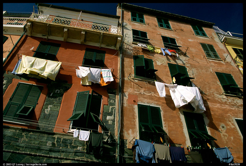 Typical terra cotta facade with clothelines and green shutters,  Vernazza. Cinque Terre, Liguria, Italy