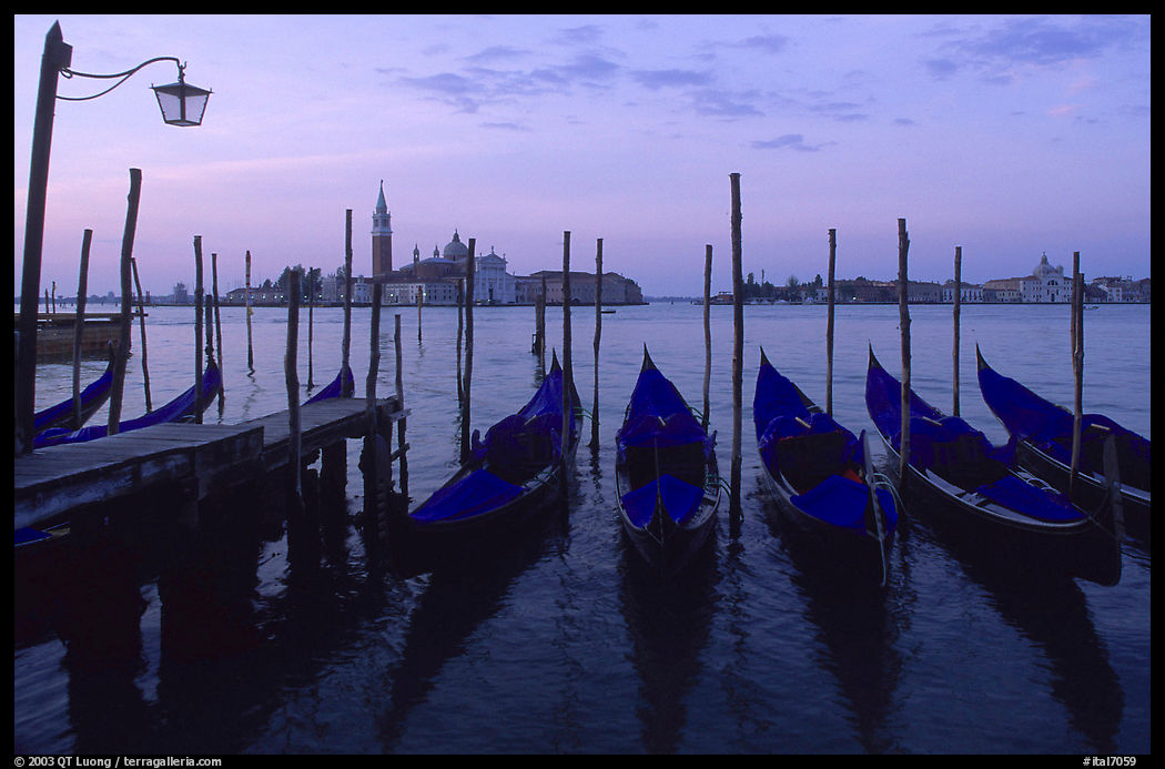 Parked gondolas, Canale della Guidecca, San Giorgio Maggiore church at dawn. Venice, Italy