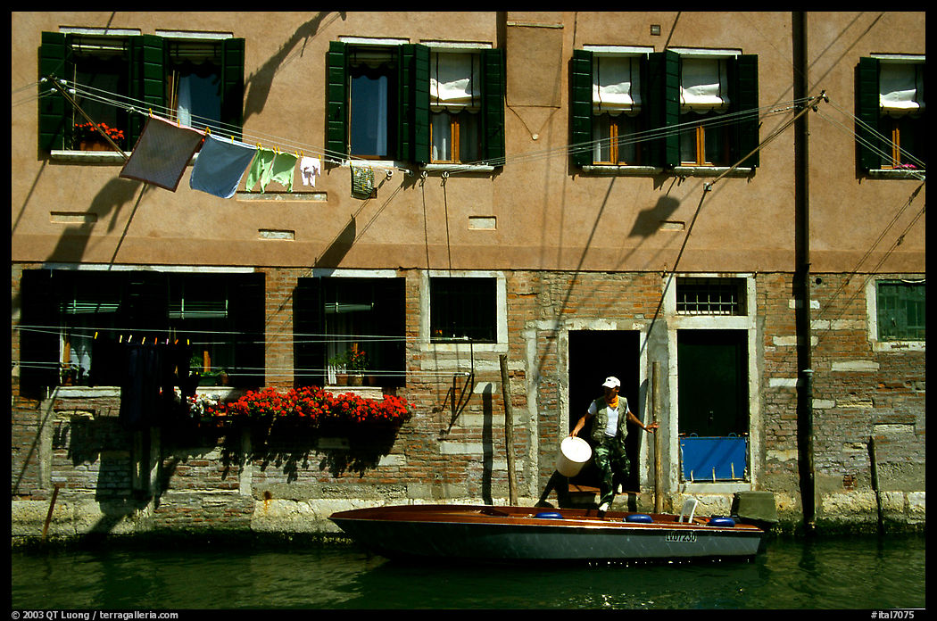 Resident stepping from his boat to his house,  Castello. Venice, Veneto, Italy