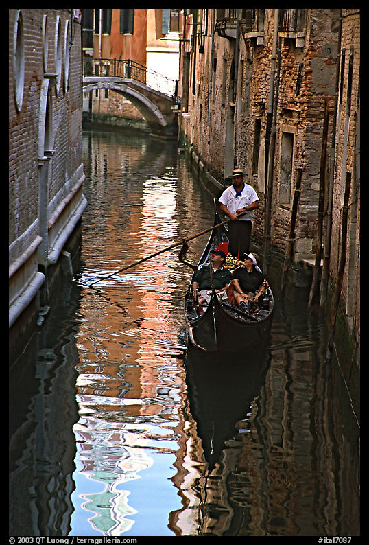 Gondola and reflexions in a narrow canal. Venice, Veneto, Italy