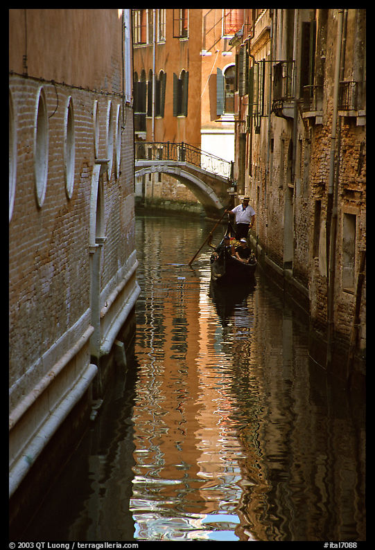 Gondola and reflexions in a narrow canal. Venice, Italy