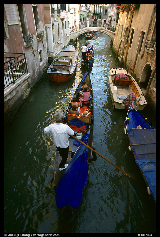 Several gondolas in a narrow canal. Venice, Italy