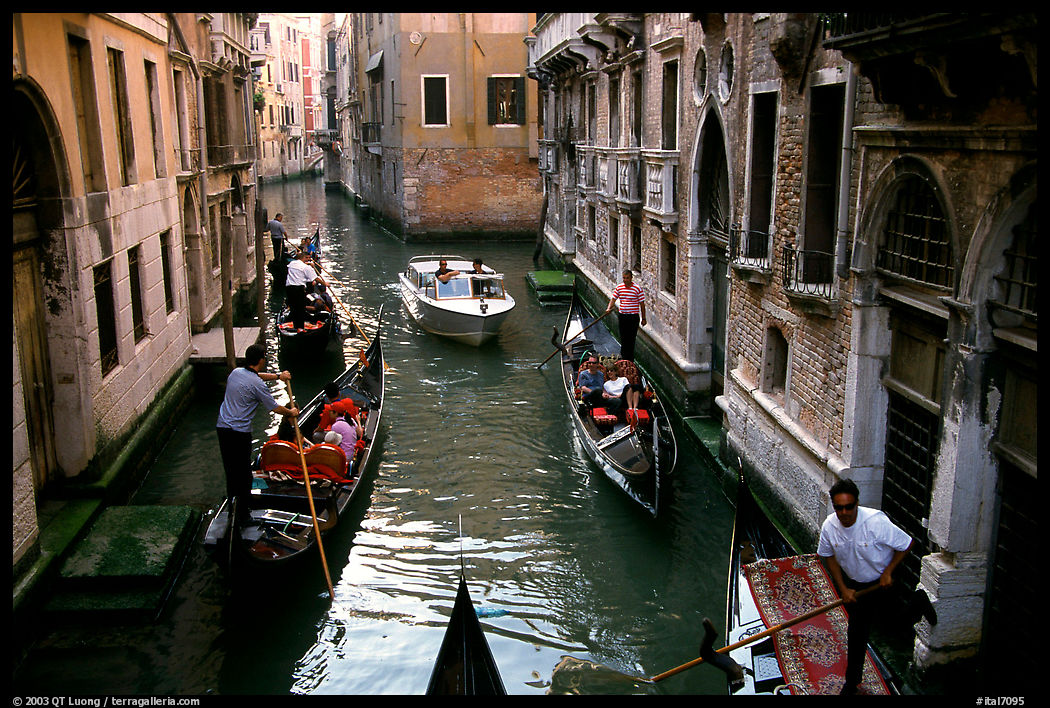 Several gondolas in a narrow canal. Venice, Veneto, Italy