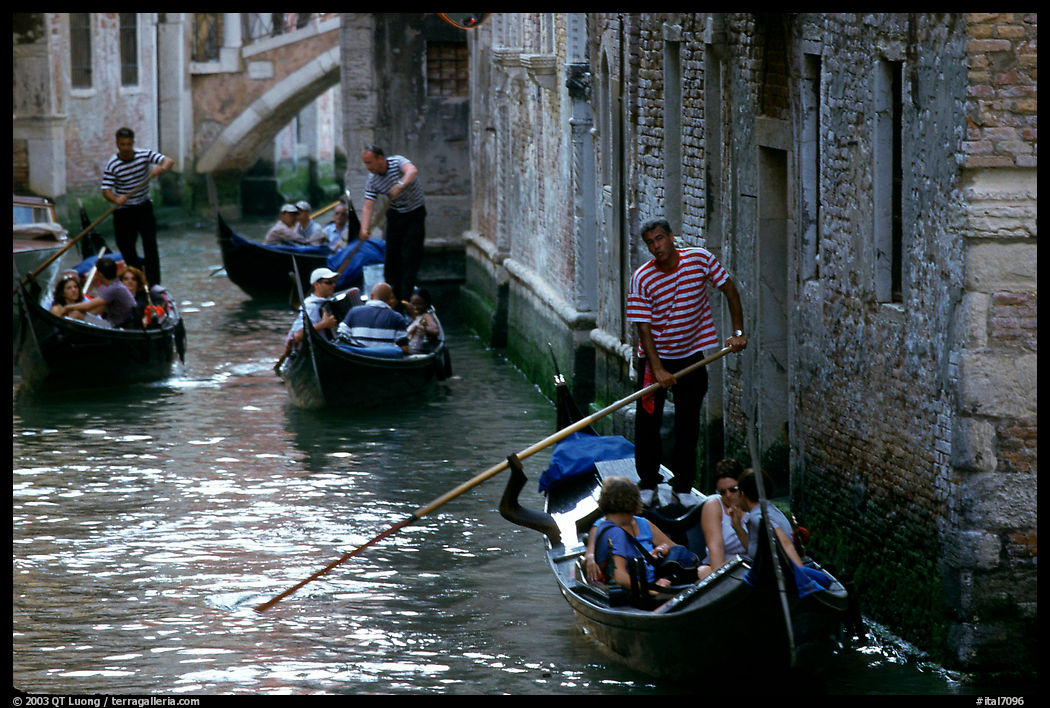 Several gondolas in a narrow canal. Venice, Veneto, Italy