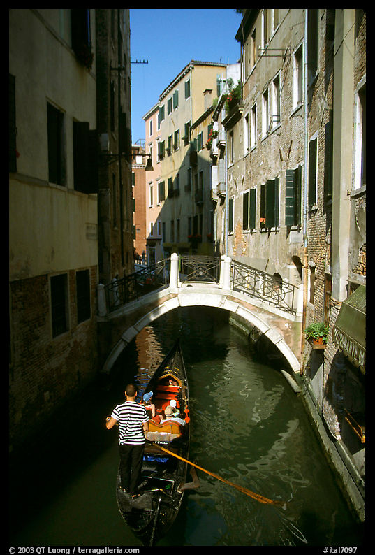 Gondola tour in a picturesque canal. Venice, Veneto, Italy