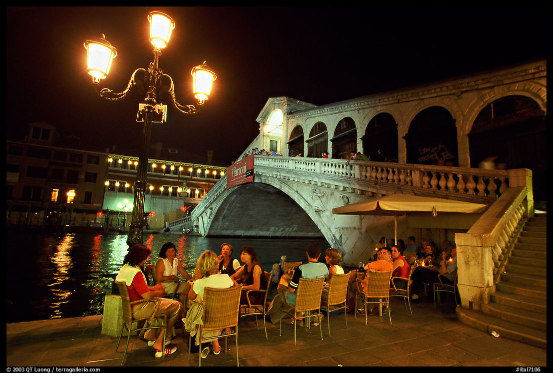 Outdoor cafe terrace,  Rialto Bridge at night. Venice, Veneto, Italy