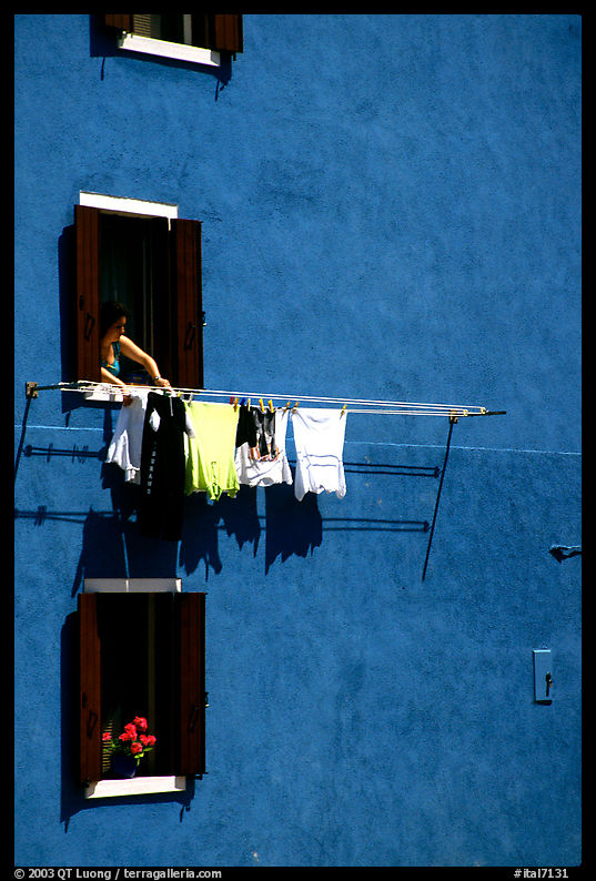 Windows, hanging laundry, blue house, Burano. Venice, Italy