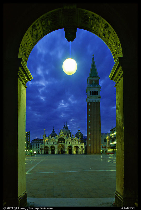 Campanile and Piazza San Marco (Square Saint Mark) seen from arcades at night. Venice, Veneto, Italy