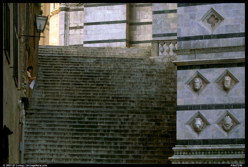 Woman cleaning up besides the Duomo stairs. Siena, Tuscany, Italy