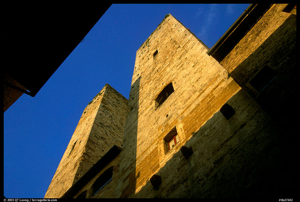 Medieval tower seen from the street, early morning. San Gimignano, Tuscany, Italy